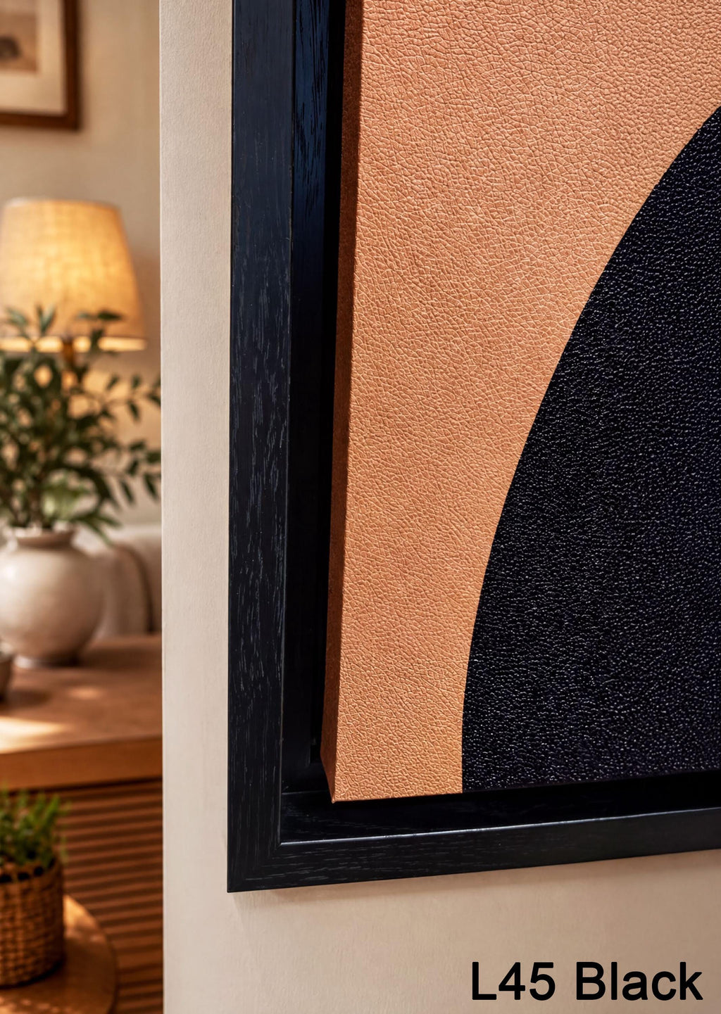 a black and orange abstract artwork with a black frame, displayed on a wall.