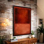 a modern interior design with a large red abstract painting hanging on a brick wall above a wooden console table. The table has various decorative items, including a potted plant, a vase, and a stack of books. The overall color scheme of the room is predominantly red and brown, with the brick wall and wooden console table providing a warm and rustic contrast.