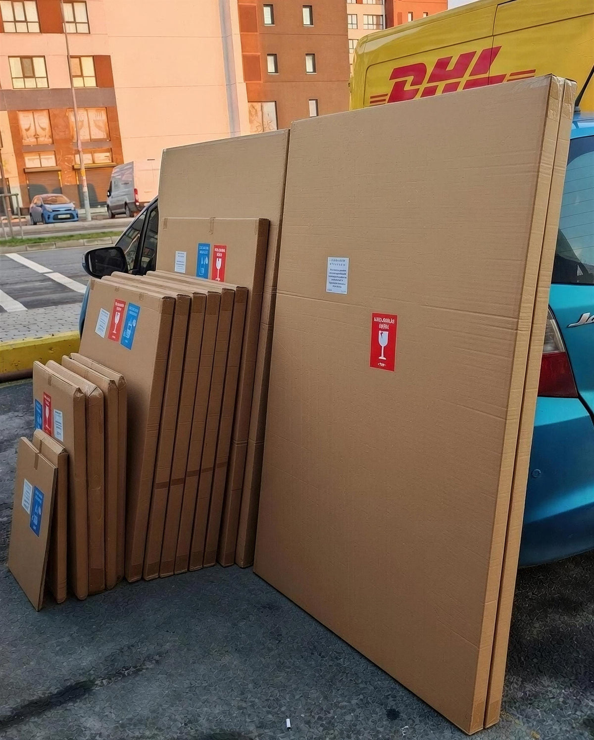 A collection of cardboard boxes and a DHL van are visible in the image.