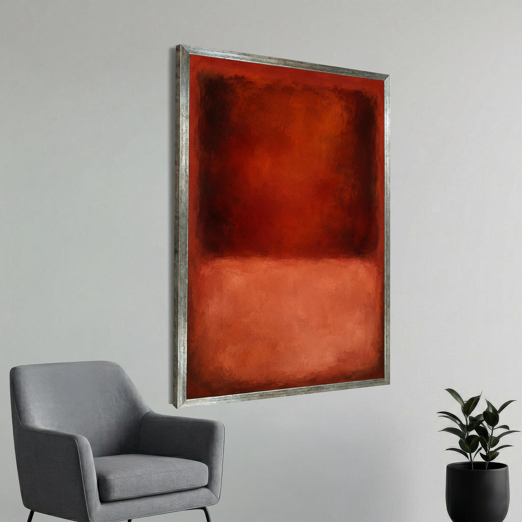 a large, abstract painting with a bold red and orange color scheme, hanging on a white wall next to a gray armchair.